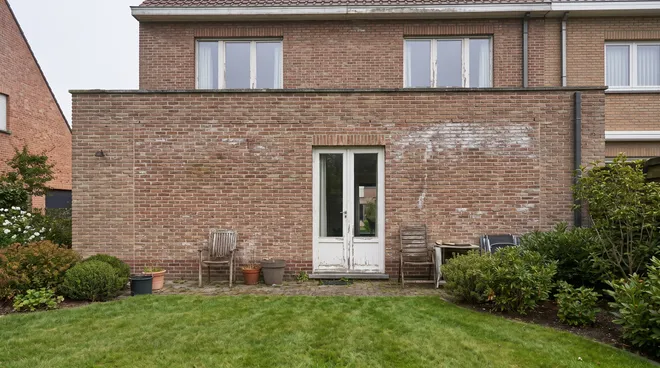 BEFORE photo — closed living room, small French door onto the garden